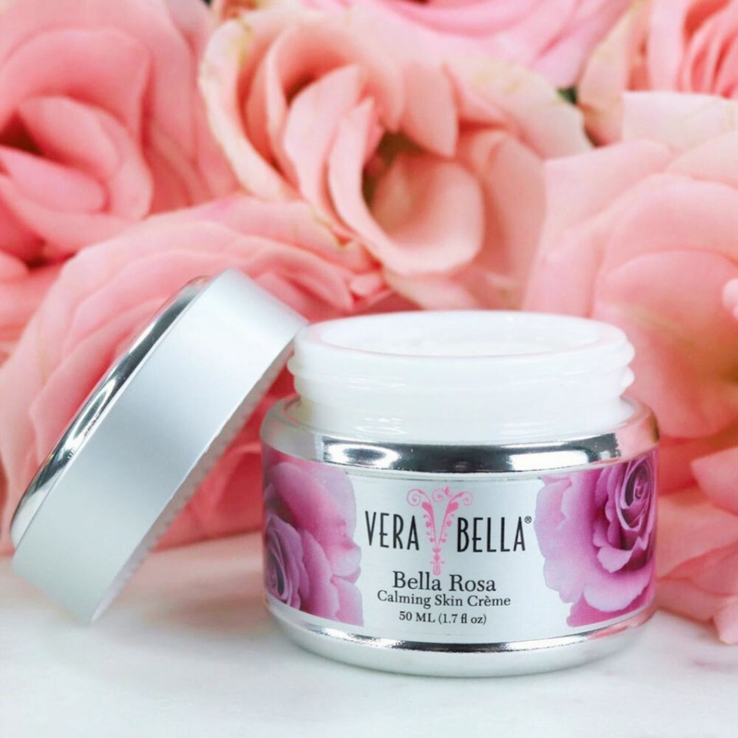 Verabella Bella Rosa cream jar with pink roses in the background