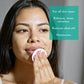 Woman applying VERABELLA Herbal Beautea Skin Tonic with cotton pad
